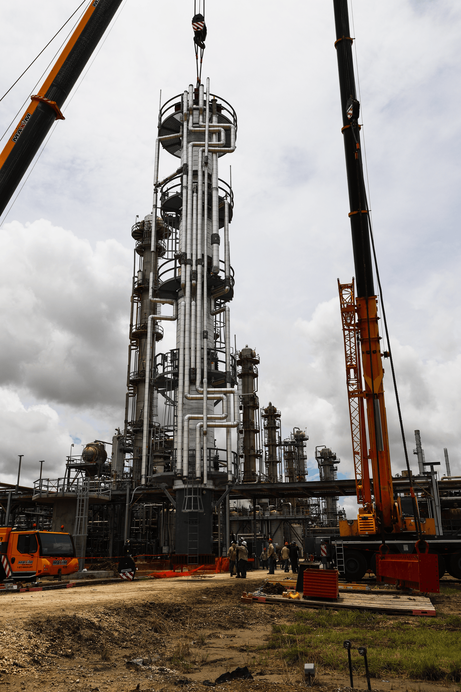 A GCAW-built process column being set at a refinery by crane